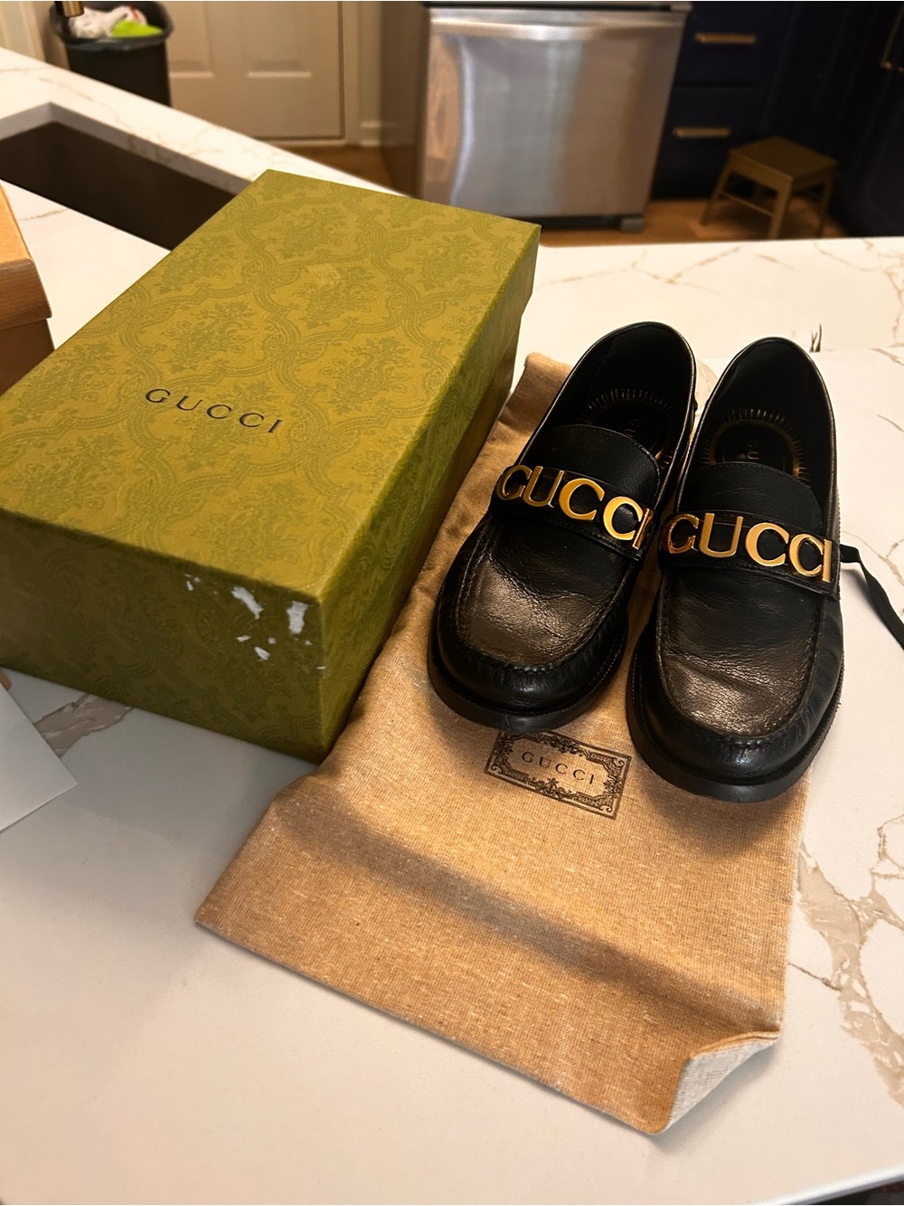 Gucci Black Leather Women's Loafers with Gold Logo Strap